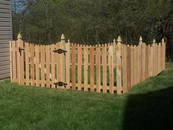 Cedar picket fence with decorative post caps built by Armitage Fence