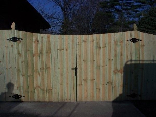 Custom wood privacy gate with decorative hardware by Armitage Fence